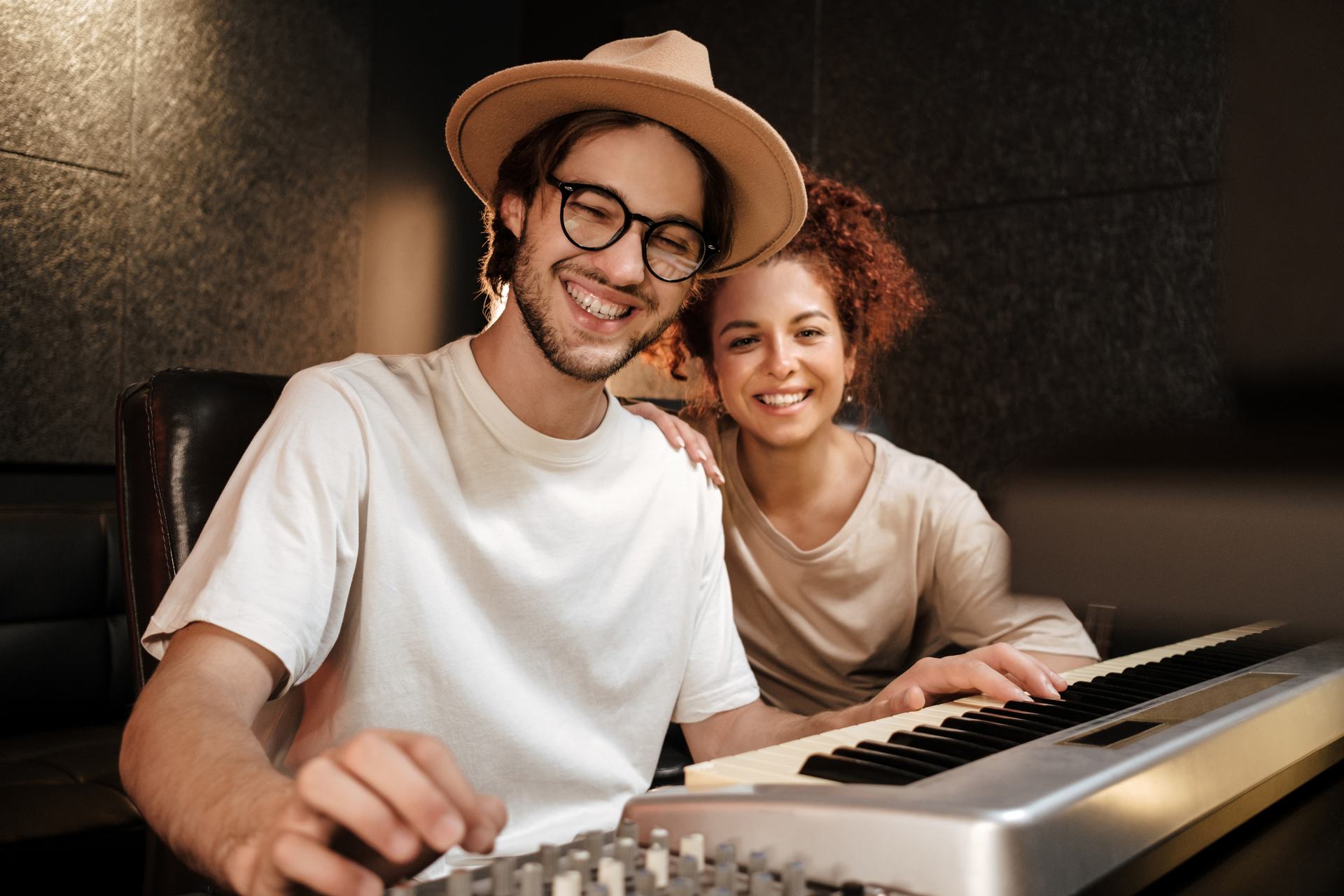 cheerful-musicians-happily-looking-in-camera-recor-AJMLHS2